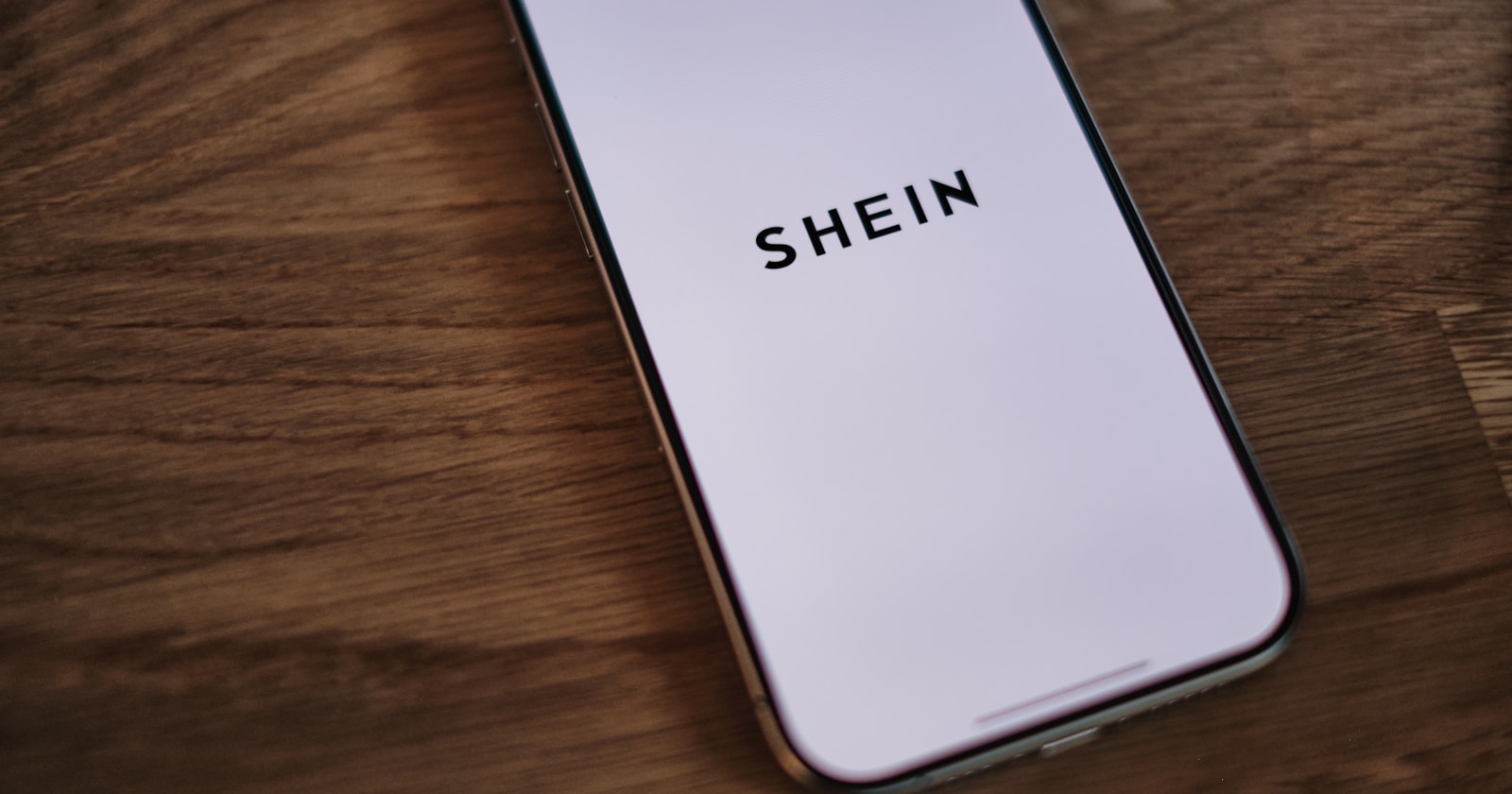 A phone that is sitting on a table — featured photo for SHEIN Membership – 4 Tiers of Rewards (Unsplash)